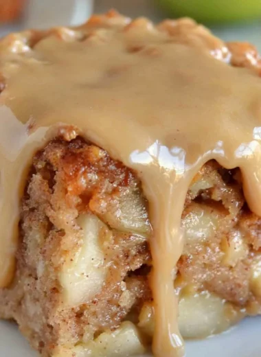Delicious Apple Dapple Cake with fresh apples and caramel glaze on a rustic plate