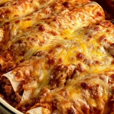 Delicious cheesy beef and cheese enchiladas served with fresh toppings