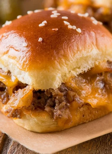 Delicious cozy cheeseburger sliders served on a rustic wooden table.