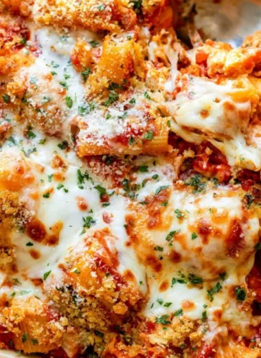 Cozy Chicken Parmesan Casserole topped with melted cheese and herbs