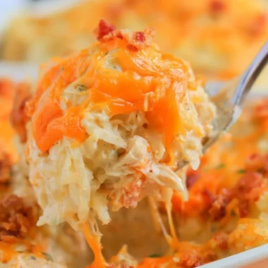 Cozy Crack Chicken Casserole topped with cheese and herbs