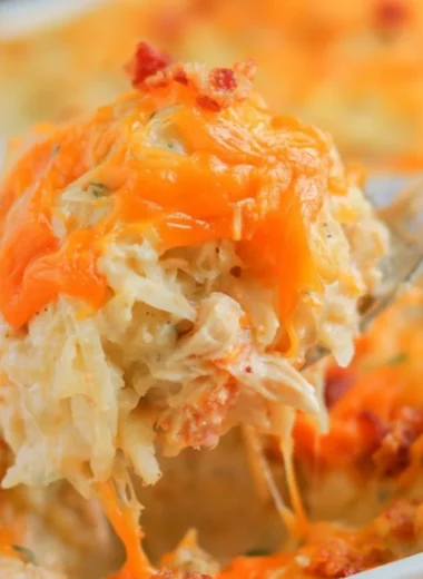 Cozy Crack Chicken Casserole topped with cheese and herbs