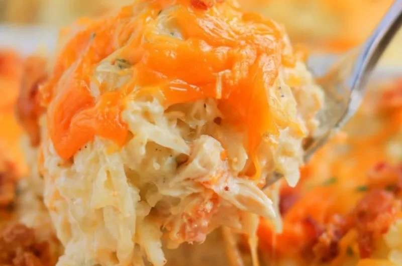 Cozy Crack Chicken Casserole topped with cheese and herbs