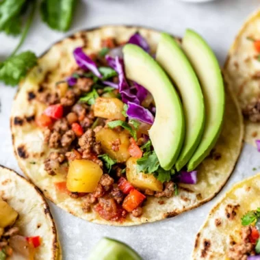 Delicious cozy pineapple turkey tacos served on a plate with fresh toppings