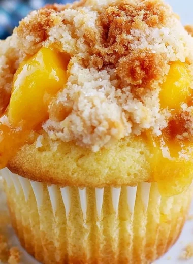 Delicious peach cobbler muffins with crumble topping fresh out of the oven