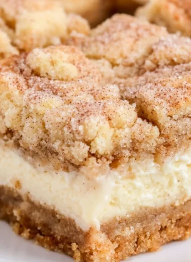Delicious snickerdoodle cheesecake bars topped with cinnamon sugar