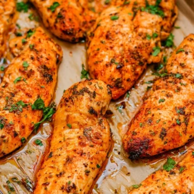 Warm and crispy oven baked chicken tenders served on a plate.