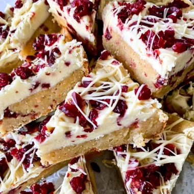 Delicious Starbucks copycat Cranberry Bliss Bars with cream cheese frosting and cranberries